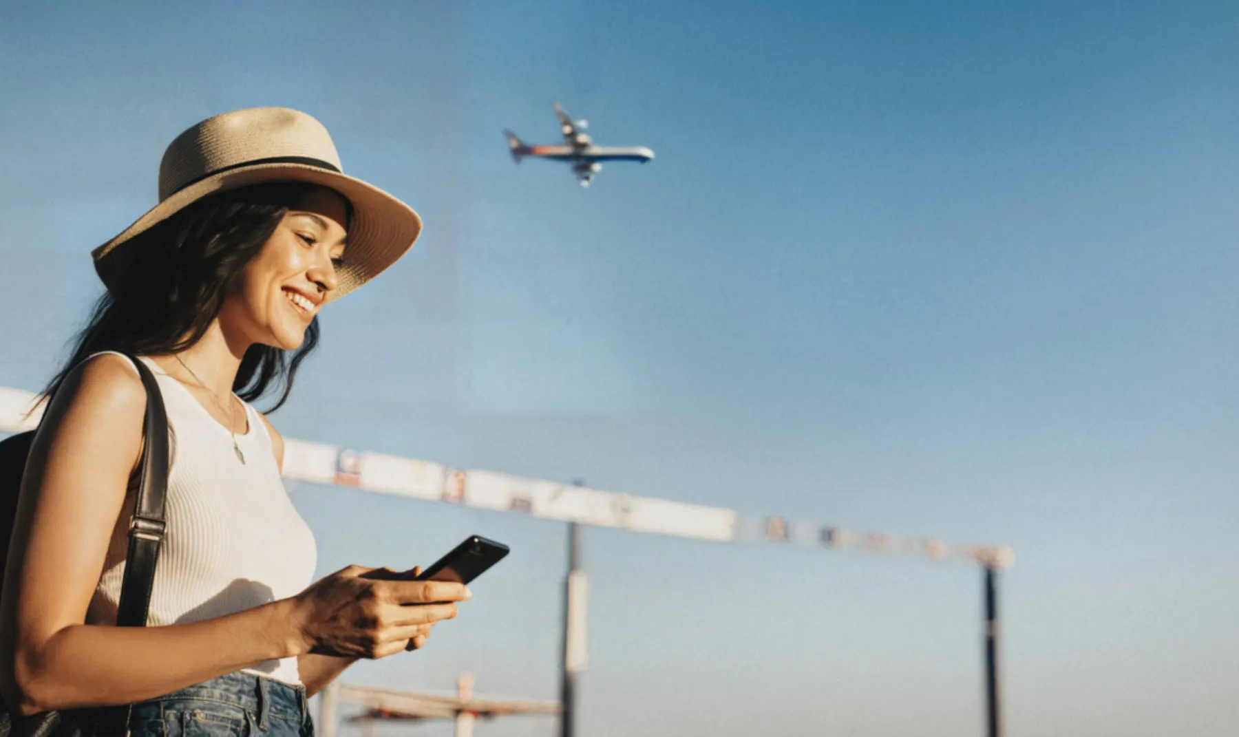 Traveler checking insurance on phone at the airport